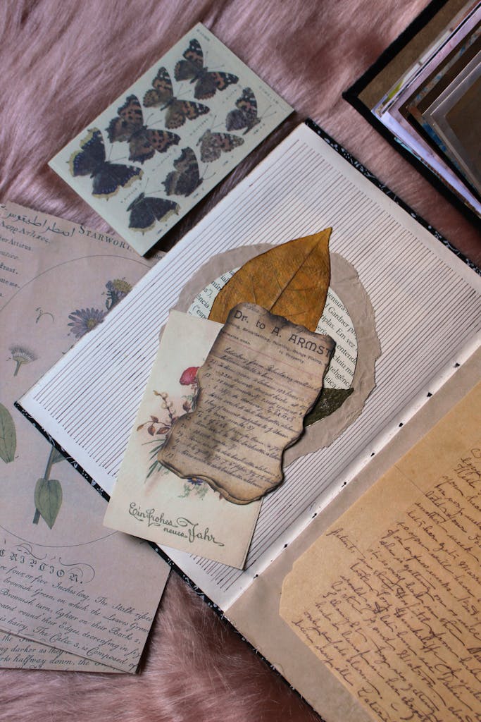 Artistic vintage journal with dried leaves and butterflies, perfect for nostalgia projects.